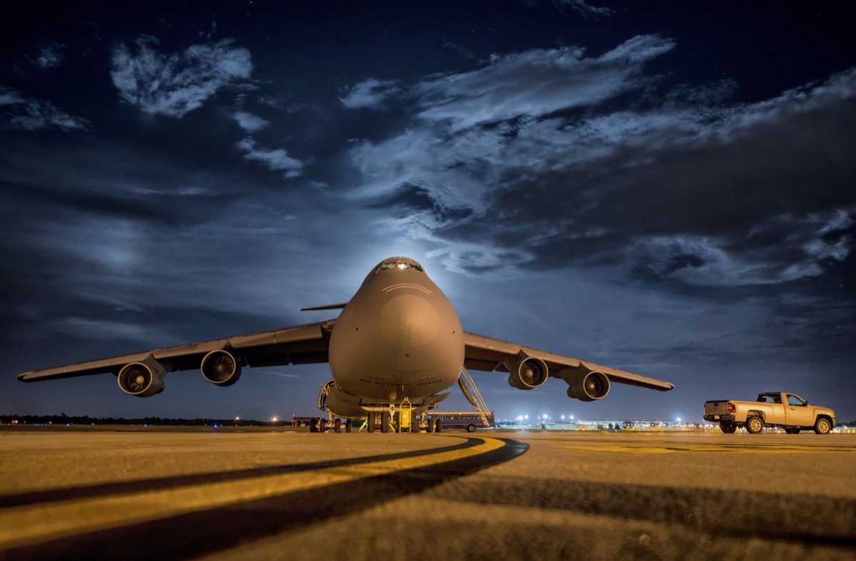 Military airfield with fighter jets on the tarmac during sunset